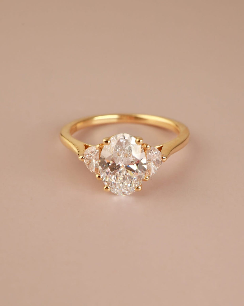 Trilogy Engagement ring with Oval shape Lab Grown diamond in the centre and Half moon side stones