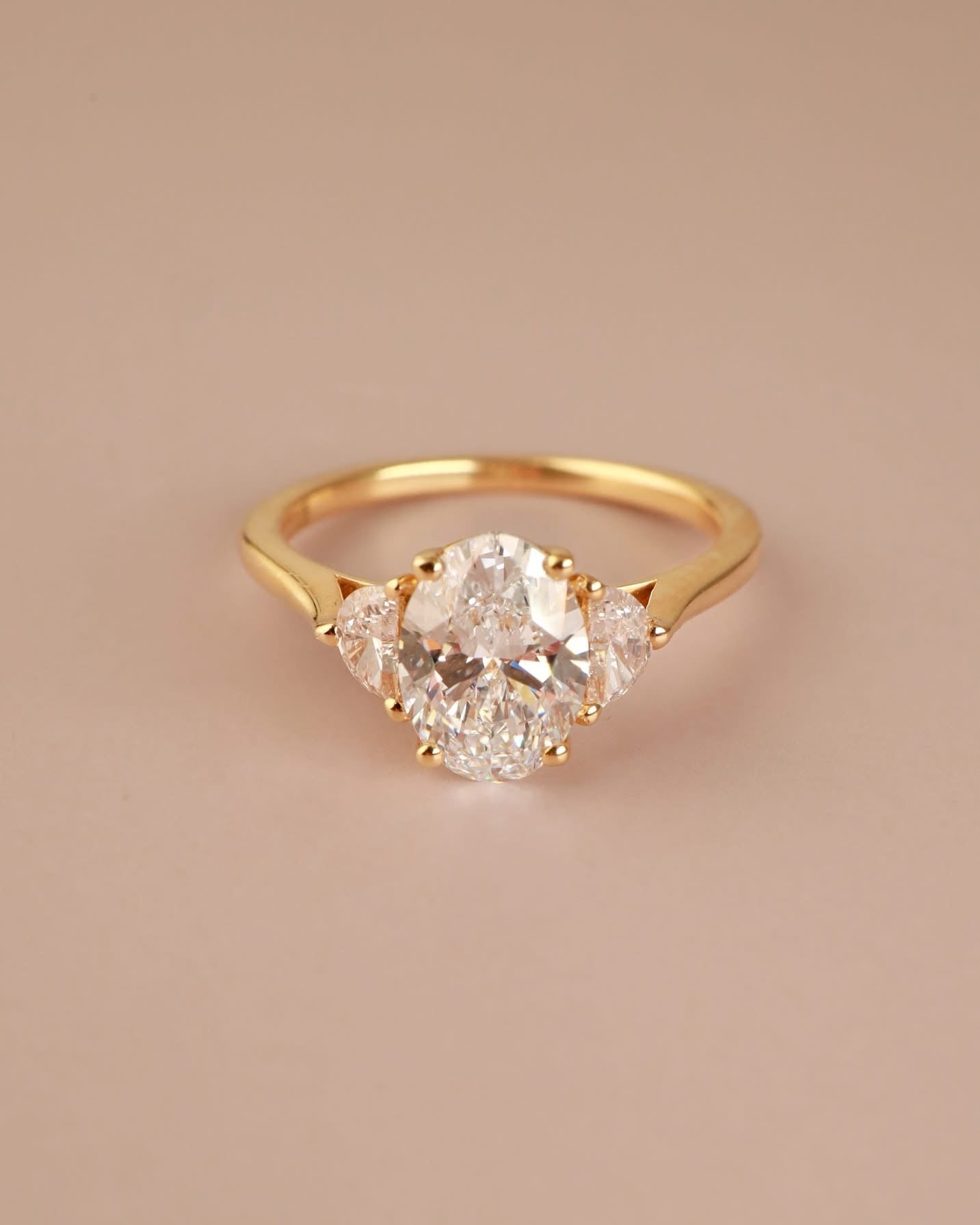 Trilogy Engagement ring with Oval shape Lab Grown diamond in the centre and Half moon side stones