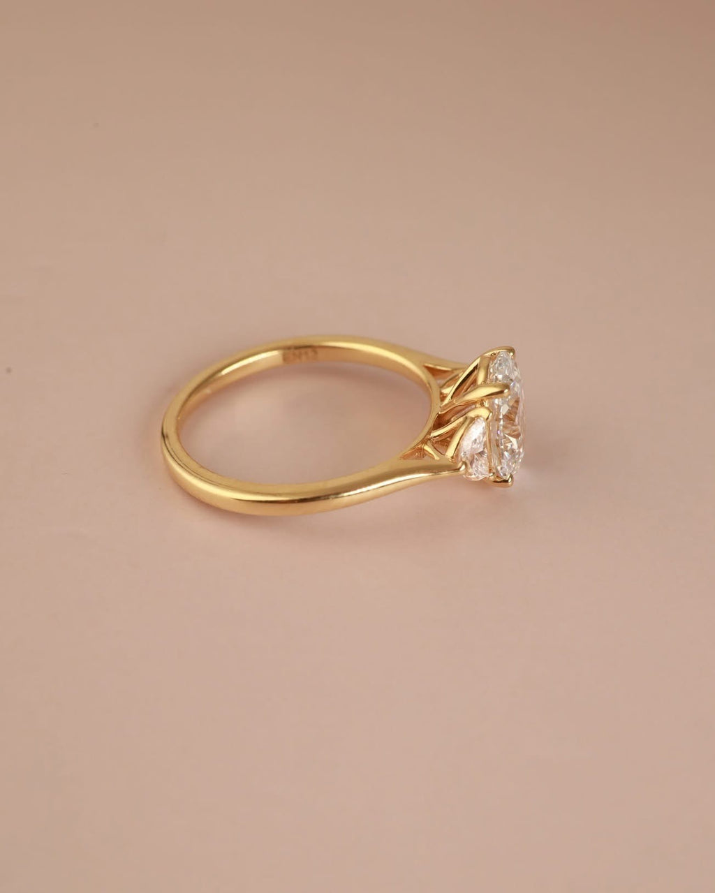 Trilogy Engagement ring with Oval shape Lab Grown diamond in the centre and Half moon side stones
