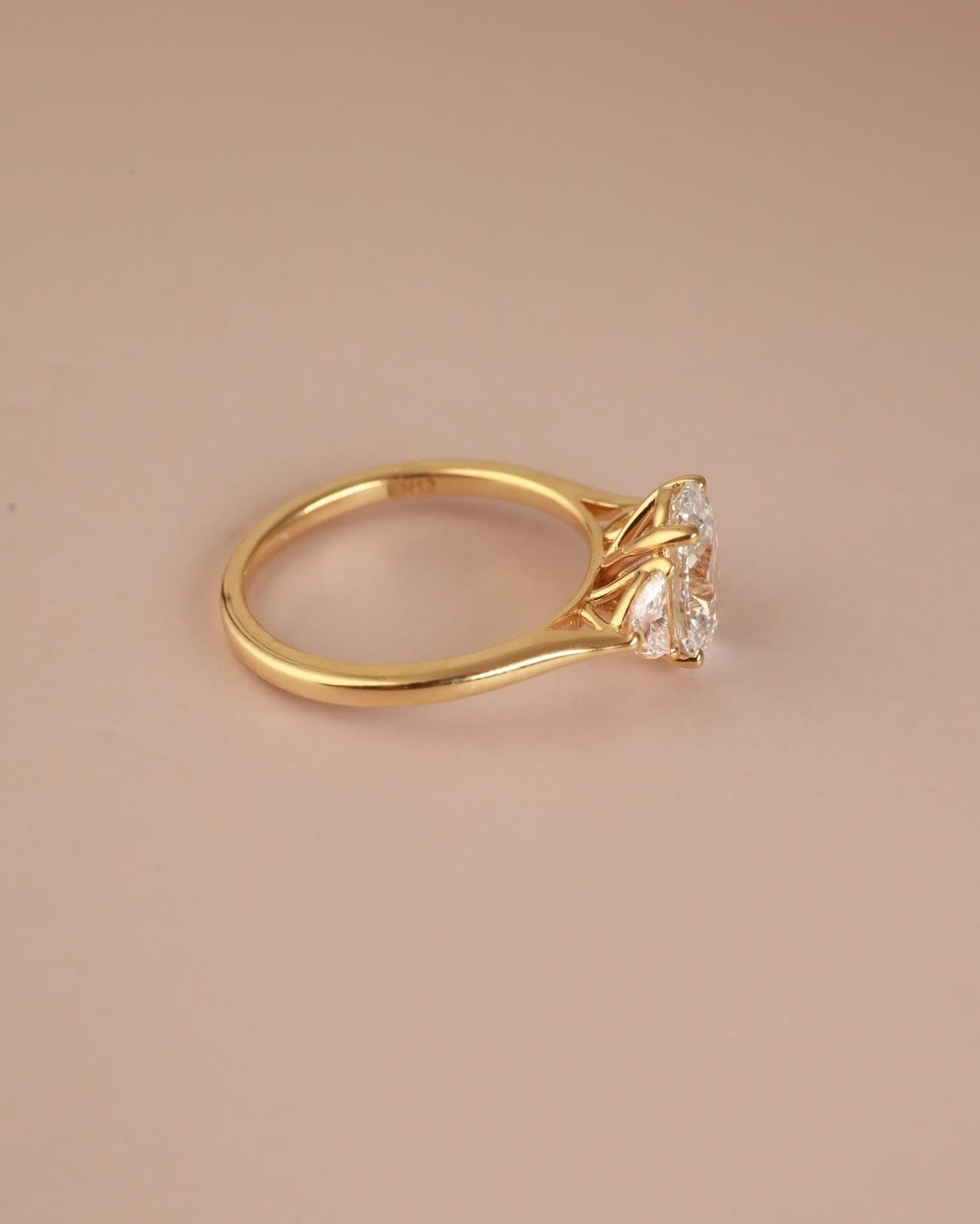 Trilogy Engagement ring with Oval shape Lab Grown diamond in the centre and Half moon side stones